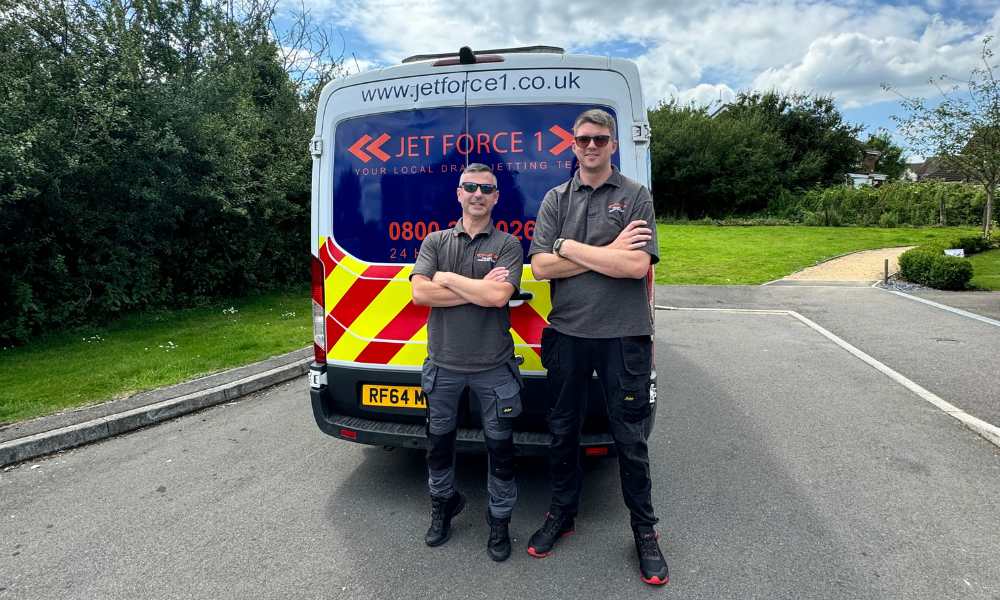 Aran & drain engineer stood behind a branded Jet Force 1 van. For page, drain rodding