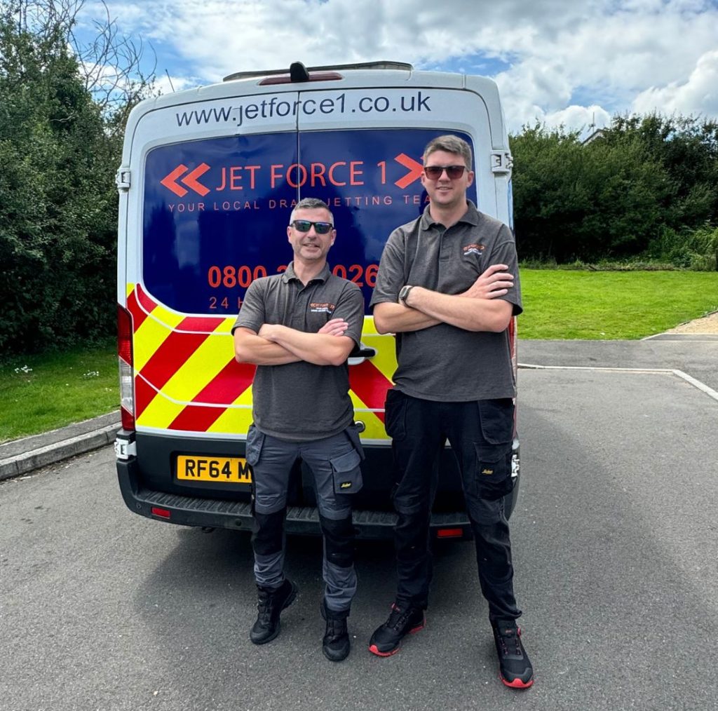 Aran and a drain engineer team member stood behind a branded jet force 1 van, for page emergency drain unblocking